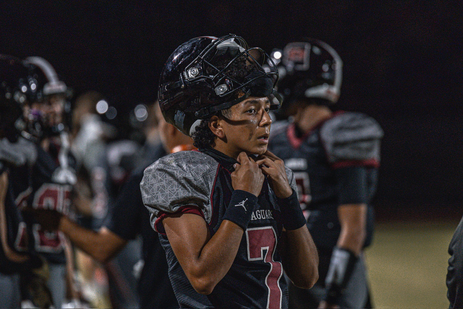 Football player on the sidelines at a game