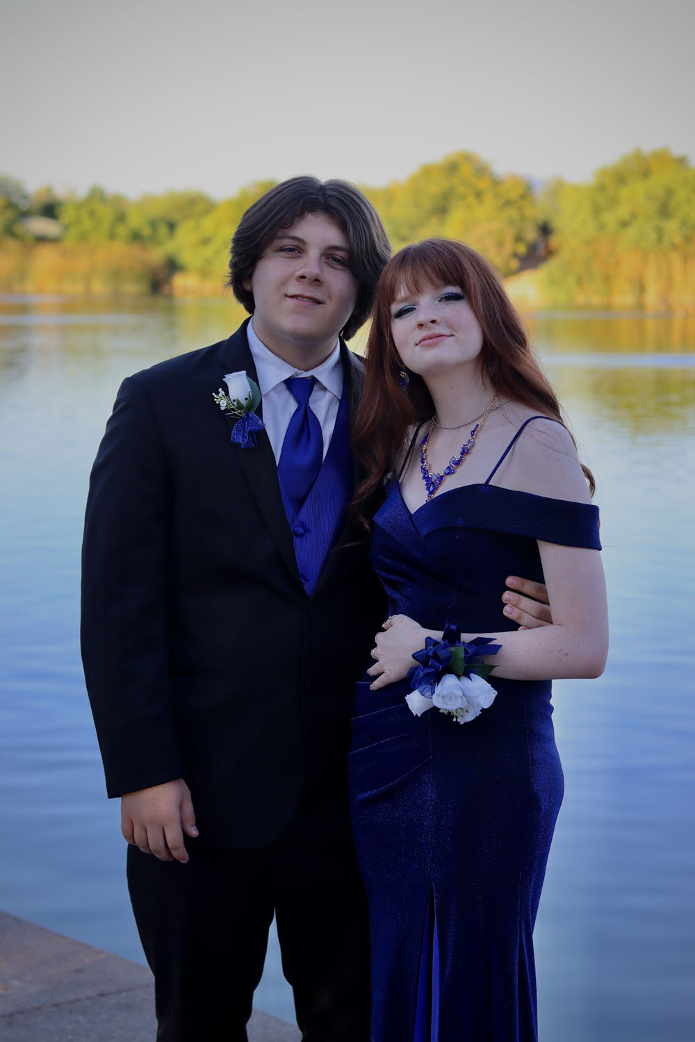 A couple in front of a pond A couple in front of a pond