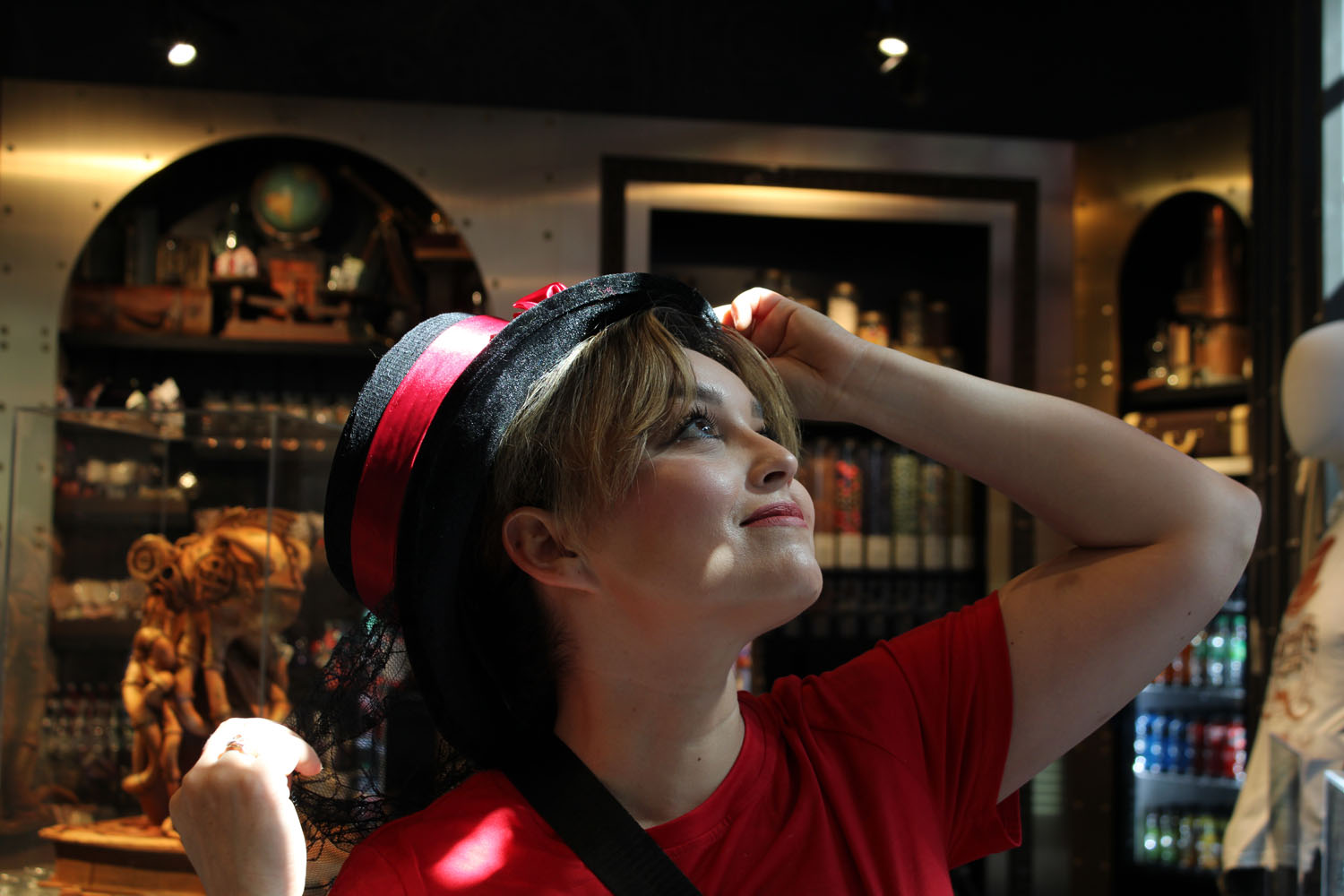 Mom looking up at the ceiling wearing a big hat Mom looking up at the ceiling wearing a big hat